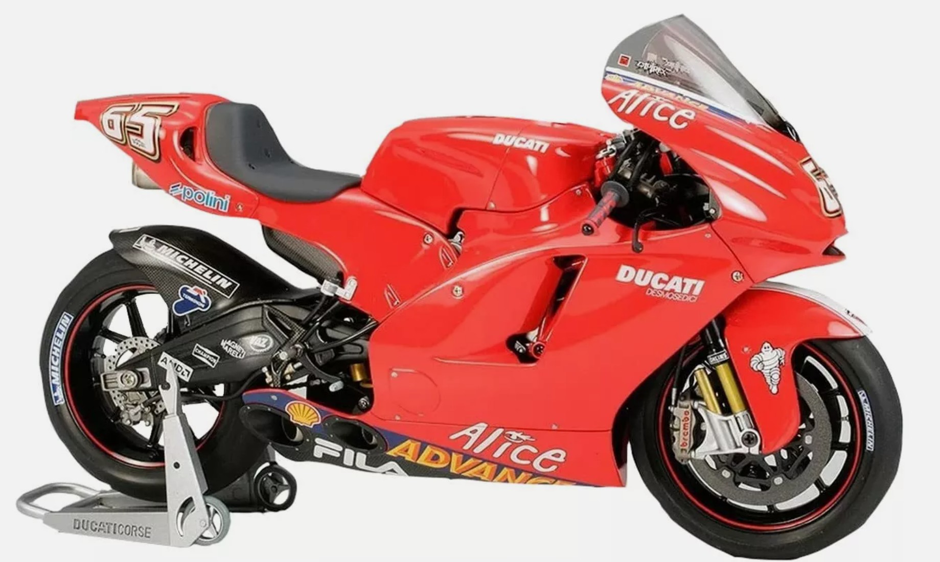 Red Ducati Tamiya Model racing motorcycle, side view, with sponsor logos and sleek design.