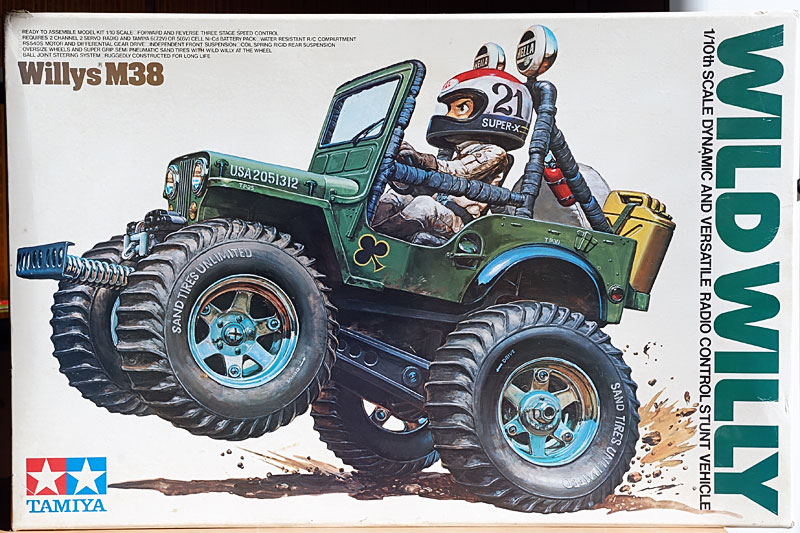 Tamiya Wild Willy M38 model kit box featuring an illustrated stunt jeep with oversized tires.